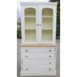 A pine dresser / bookcase, with glazed upper cupboard, and four long drawers, 96 by 196 by 45cm.