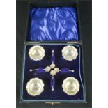 A set of four silver salts, with original spoon and box.