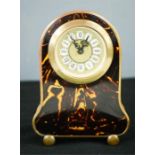 A faux tortoiseshell mantle clock, circa 1960, with Roman Numeral dial, 14cm high.