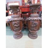 A large pair of Chinese urns, cast with elephant head handles and figural scenes.