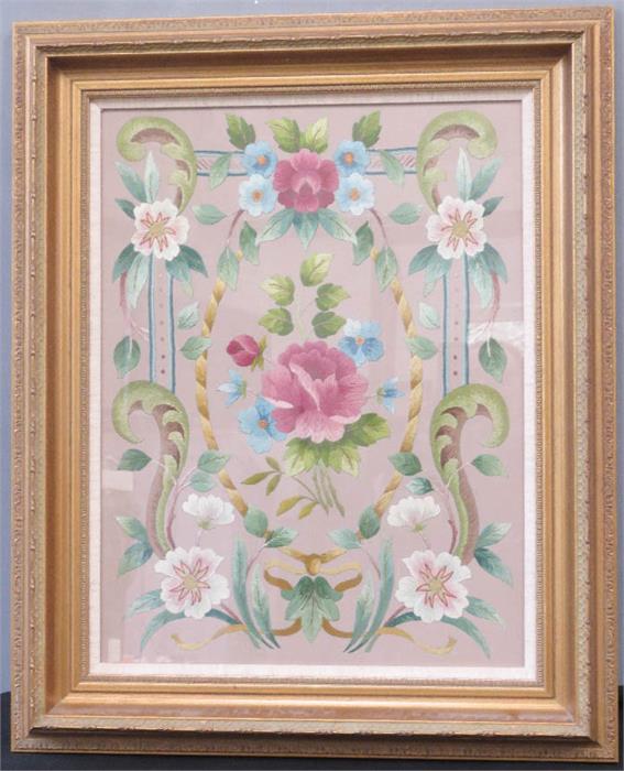 A silk embroidered panel, depicting a stylised floral group, in a glazed giltwood frame, 51 by 40cm.