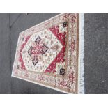 A Persian Heriz deign beige and red ground rug / wall hanging 230 by 160cm.