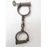 A pair of iron shackles / handcuffs.