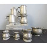 A group of early pewter measures, tankards and jar and cover.