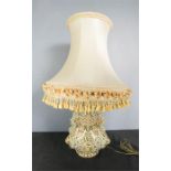 A porcelain table lamp, majolica style, with cream silk shade.