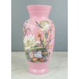 A pink bohemian glass vase, painted with flowers, and a bird of paradise.