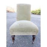 A Victorian nursing chair upholstered in velvet.