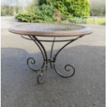 An oak and iron lattice top table, the circular top measures 106cm diameter, 75 high.