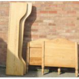 A child's pine sleigh bed.