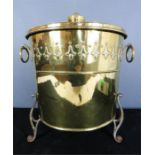 A brass Art Nouveau bucket with embossed bell flowers, and iron feet, 39cm high.