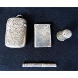 A group of two vesta cases, thimble and toothpick.