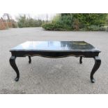 A Chinese hand painted black lacquered coffee table, 98cm wide by 50cm deep.