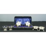 A pair of silver salts, with pierced sides, a boxed pair of silver plated salts, and a pair of