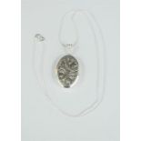 Georg Jensen sterling silver locket and chain with chased floral design.