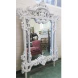 A Rococo style pier mirror, painted white, 180cm high by 126cm wide.