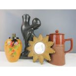 A terracotta tea pot, giltwood wall mirror starburst, a ceramic lamp base, and ebonised ceramic
