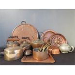A group of brassware including kettles, jelly mould trays, charger etc.