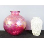 Two iridescent glass vases, one of ovoid form in pink, the other baluster vase in white.