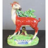 A 19th century Staffordshire figure of a deer, 18 by 15 by 8cm.