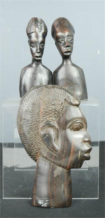 Three African carved heads.