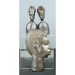 Three African carved heads.