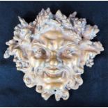 A brass cast Bacchus mask, 16 by 17cms.