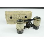 A pair of French opera glasses, clad in snake skin and original matching snake skin case.