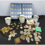 A coin Library album together with loose coins.