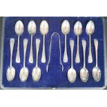 A set of twelve silver spoons with sugar tongs, in original box.