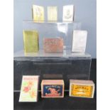 Six matchbox holders and three matchboxes.