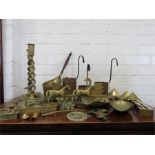 Two brass scoops, various spirit measures, horse brasses, candle sticks etc.