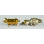 A brass match striker in the form of a pig, together with a silver plated rattle charm.