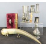 A group of pewter including early beaker, and Victorian album, and horn on stand.