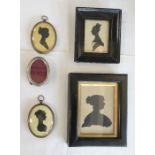A group of miniature silhouettes: an oval pair, one painted with detail and a silver plated oval