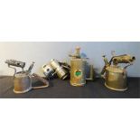 An antique bicycle lamp and three brass blow torches.