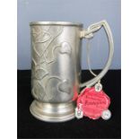 An Art Nouveau continental pewter tankard with impressed marks and the original label. 13cm high.