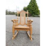 A beech caned rocking chair.