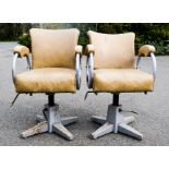 A pair of vintage swivel base dentist chairs.