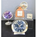 A group of five retro clocks.