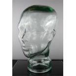 A glass milliners head, 29cm high.