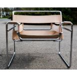 A Wassily polished steel and tan leather chair designed by Marcel Breuer, 78cm wide. [Provenance: