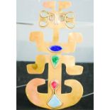 An Arts & Crafts copper and enamel stylised figure 20cm high by 11cm.
