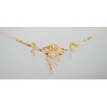 A 15ct gold and seed pearl necklace, the central flowerhead flanked by foliate spray and garland