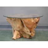 A glass top tree root table.
