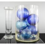 A glass vase of blue fishermans glass balls, and a glass bud vase.