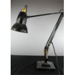 A black angle poise lamp.