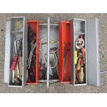 A grey tool box containing spanner, screwdrivers, hammer etc.