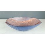 A modern glass bowl, with rippled iridescent effect.