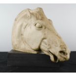 A resin carved horse head on plinth, 21cm high.