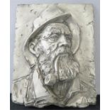 A plasterwork wall plaque modelled with the portrait of a fisherman.